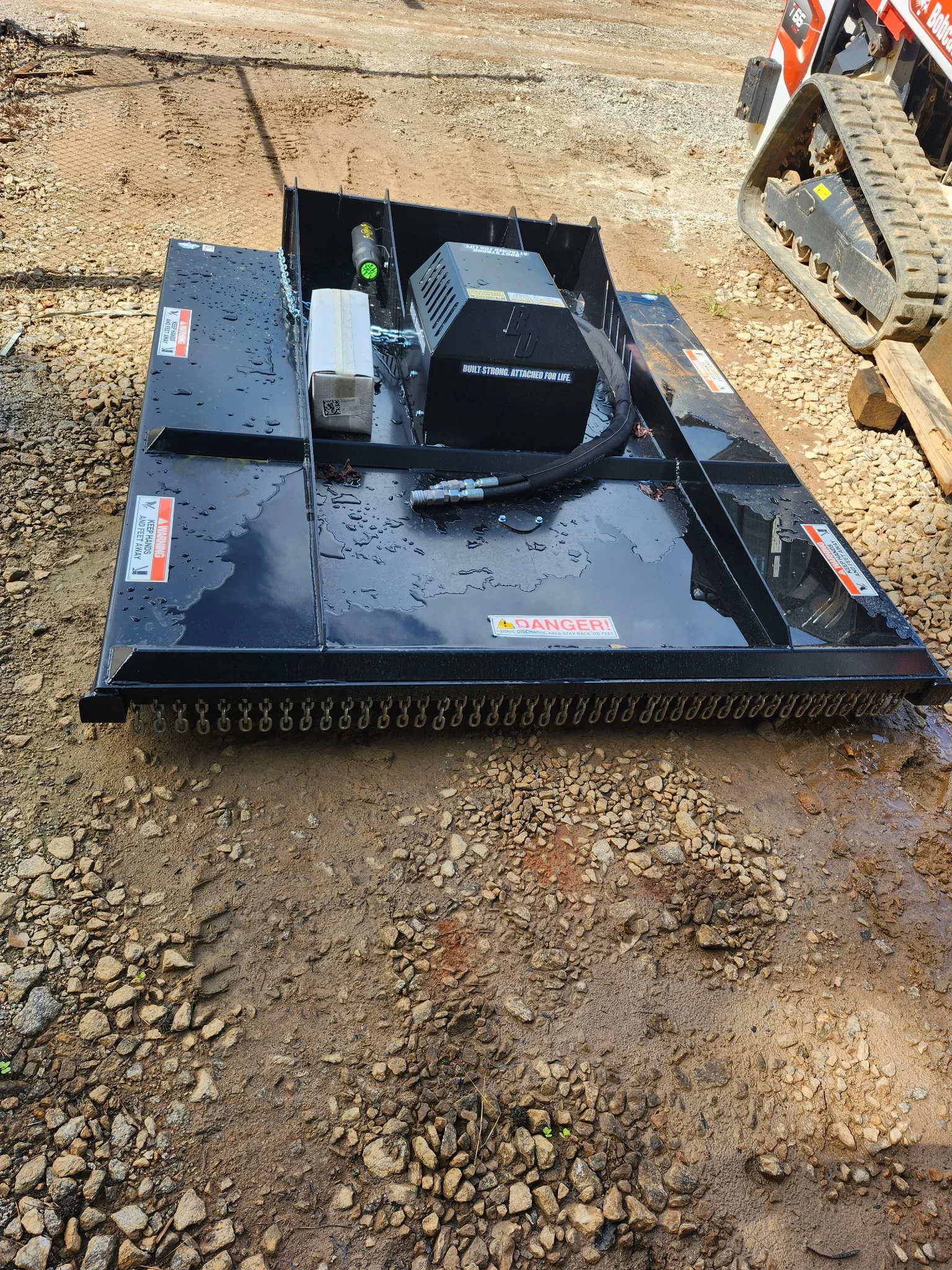 Steel mulching head attachment with hydraulic systems and control panels mounted on equipment